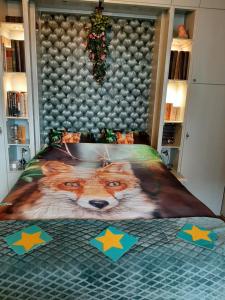 a bedroom with a bed with a fox comforter at B&B de Hartewens in Zuidland