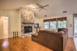 sala de estar con sofá y chimenea de piedra en Charming Waldo Getaway Near Lake Santa Fe!, en Waldo