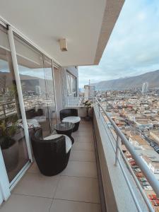a balcony with couches and a view of a city at Pleno centro de iquique in Iquique