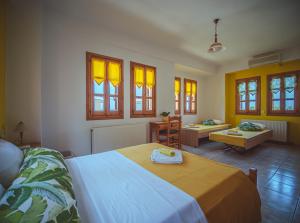 a bedroom with a large bed and a living room at Lemon House for big family in Damouchari - Delicious Houses in Damouchari