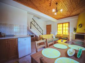 a kitchen and living room with a table and a dining room at Lemon House for big family in Damouchari - Delicious Houses in Damouchari