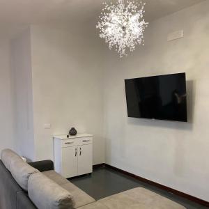 a living room with a couch and a flat screen tv at Villa Manzo relais -Pompei Vesuvius in Boscotrecase