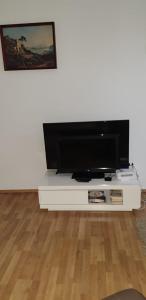 a flat screen tv sitting on a white entertainment center at Ferienwohnung Schloessel 26-26 in Vienna