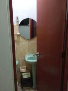 La salle de bains est pourvue d'un lavabo et d'un miroir. dans l'établissement HOSTAL EL CARIBE, à Ayacucho