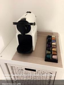 a toaster sitting on top of a shelf with cosmetics at Essence Domus Vaniglia in Matera