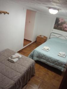 a bedroom with two beds with towels on them at Miguel y Rosa Lúcar in Lúcar