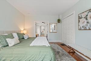 a bedroom with a green bed and a couch at Charming 1 BR Spacious Retreat [Sage Suites] 