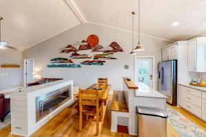 a kitchen with a dining room and a kitchen with a table at Sea N Red - upper in Oak Island