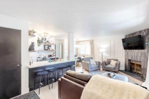 a living room with a couch and a bar at Lakeview 11 in McCall