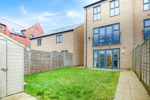 a brick house with a fence and a yard at Alpha Properties 1 - Luxury One Bedroom within a Shared Four Bedroom House with Free Parking, Fast Wifi, SmartTV with Netflix in Milton Keynes