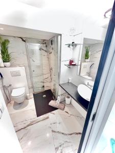 a bathroom with a toilet and a sink at Fabulous Lakeside Family Apartment | 4 Rooms in Montreux