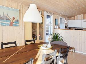 - une salle à manger avec une table et des chaises en bois dans l'établissement Holiday home Slagelse XLII, à Slagelse