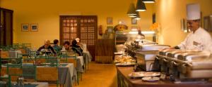a group of people sitting at tables in a restaurant at Palmera Chalets Best Vacation Group Families only in Ain Sokhna