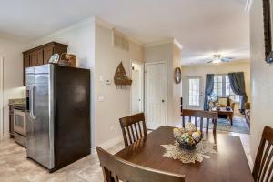 a kitchen and dining room with a table and a refrigerator at Dawn 722-Poolside Paradise in Galveston