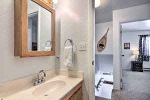 a white bathroom with a sink and a mirror at Peaceful Utah Ski-InandSki-Out Vacation Rental! in Beaver +17 photos