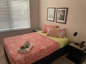 a bedroom with a bed with two towels on it at City centre, tropical home, minutes walk to shops. in Cairns