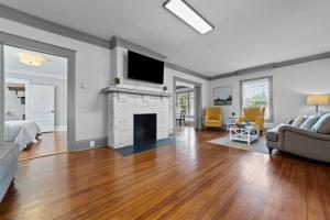 a living room with a couch and a fireplace at Beautiful Historical home in Fisher Park! 4BR 3BA in Greensboro