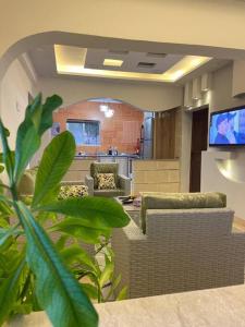 a living room with couches and a flat screen tv at بيت العُمري (ام قيس) in Um Qeis