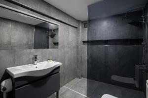 a bathroom with a sink and a shower at Via Çırağan Hotel in Istanbul