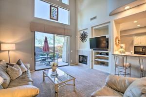 a living room with a couch and a table at Elegant Scottsdale Townhome with Heated Pool! in Scottsdale