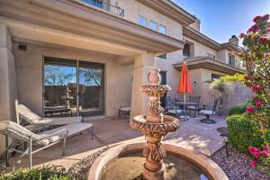 a fountain in the yard of a home with a patio at Elegant Scottsdale Townhome with Heated Pool! in Scottsdale