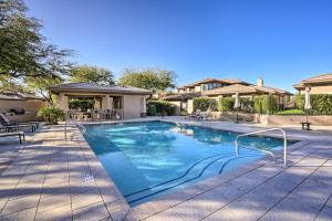 a swimming pool with blue water in a yard at Elegant Scottsdale Townhome with Heated Pool! in Scottsdale