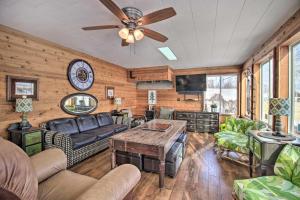 a living room with a couch and a table at Family-Friendly Ottertail Home on Rush Lake! in Ottertail