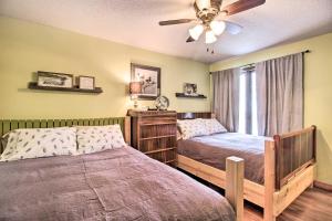 a bedroom with two beds and a ceiling fan at Family-Friendly Ottertail Home on Rush Lake! in Ottertail