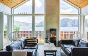 a large living room with couches and a fireplace at Stunning Home In Farsund With 4 Bedrooms, Jacuzzi And Sauna in Herad