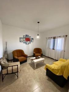 a living room with a couch and chairs and a table at Camino al Sol Domselaar wifi in Domselaar