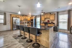 a kitchen with a large island with bar stools at Inviting Gulfport Home with Private Pool and Yard in Gulfport