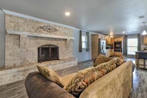 a living room with a couch and a fireplace at Inviting Gulfport Home with Private Pool and Yard in Gulfport