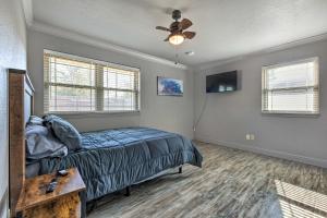 a bedroom with a bed and a ceiling fan at Inviting Gulfport Home with Private Pool and Yard in Gulfport +21 photos