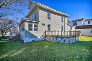 a large house with a wooden deck in the yard at Chincoteague House with Enclosed Porch and Deck in Chincoteague