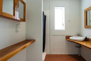 a bathroom with a sink and a mirror at GLENALMOND Country Motels in Harihari +56 photos