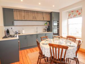 a kitchen and dining room with a table and chairs at Carnorfa in Newport Pembrokeshire