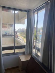 a room with a large window with a view of a city at Apartamento en Viña del Mar in Viña del Mar