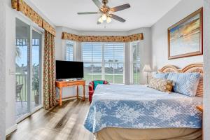 a bedroom with a bed and a flat screen tv at Fairway Vista in Naples