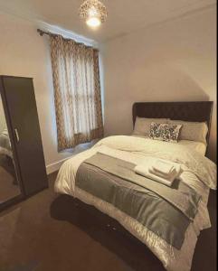 a bedroom with a large bed and a window at Two Bedroom Apartment in London in London