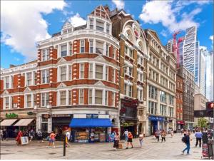 a large building on a city street with people walking around at Shoreditch & Liverpool Street Room B in London