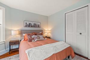 a bedroom with a bed with an orange bedspread at Family Friendly 2 Floor 2 BR Apt [Sunflower Stay] 