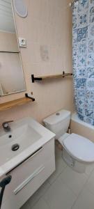 a bathroom with a sink and a toilet and a mirror at Casa Mar, studio 4P, vue mer, Sant'Ambroggio, Lumio in Lumio
