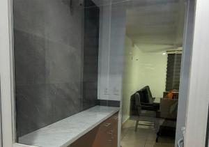 a room with a counter and a chair and a mirror at Hermoso Departamento Minimalista Acogedor En Coto in Guadalajara