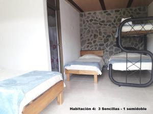a room with two bunk beds in a room at El Guadual Casa Campestre in Ibagué