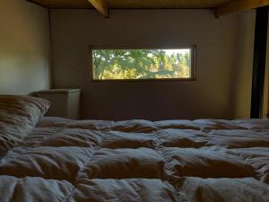 سرير أو أسرّة في غرفة في Tiny House, Cabaña