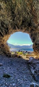 a rock cave with a view of the ocean at AWEN in Lago Meliquina