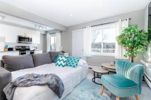 a living room with a couch and a table at Modern & Stylish 2-Bedroom Unit in Edmonton