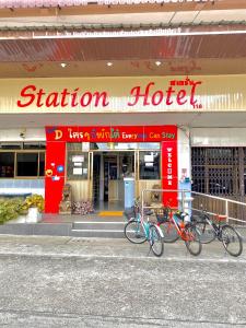 tres bicicletas estacionadas frente a un hotel de la estación en Station Hotel en Trang