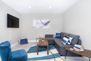 a living room with a couch and a table at Modern & Elegant 1-Bedroom Unit in Edmonton