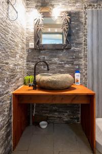 a bathroom counter with a sink and a mirror at KIA ORA LODGE in Afaahiti